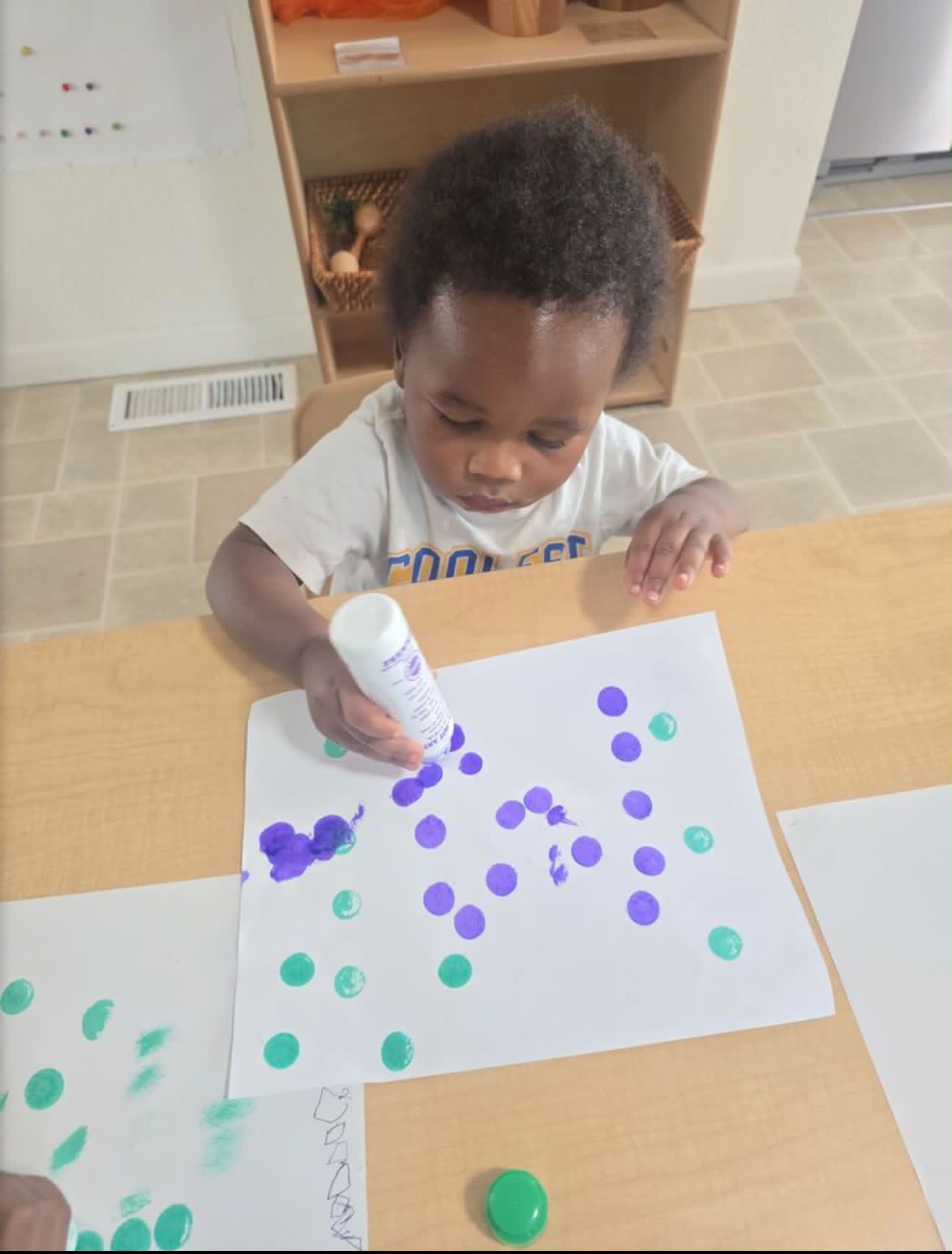 Toddler exploring colors with a dot marker