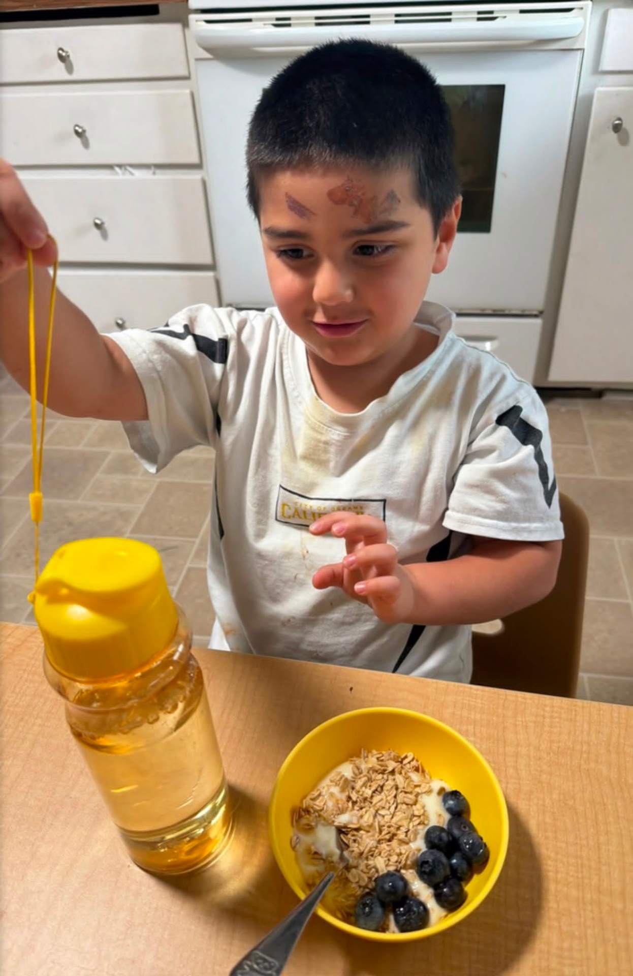 Child exploring sensory play with honey and oats